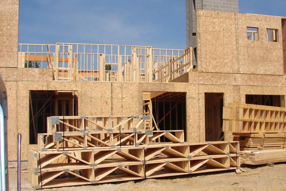 Prefabricated timber wall panels and floor cassettes staged on site ready for assembly